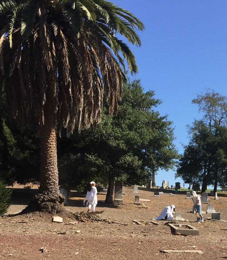 picture of shy and cca students sweeping the cemetery